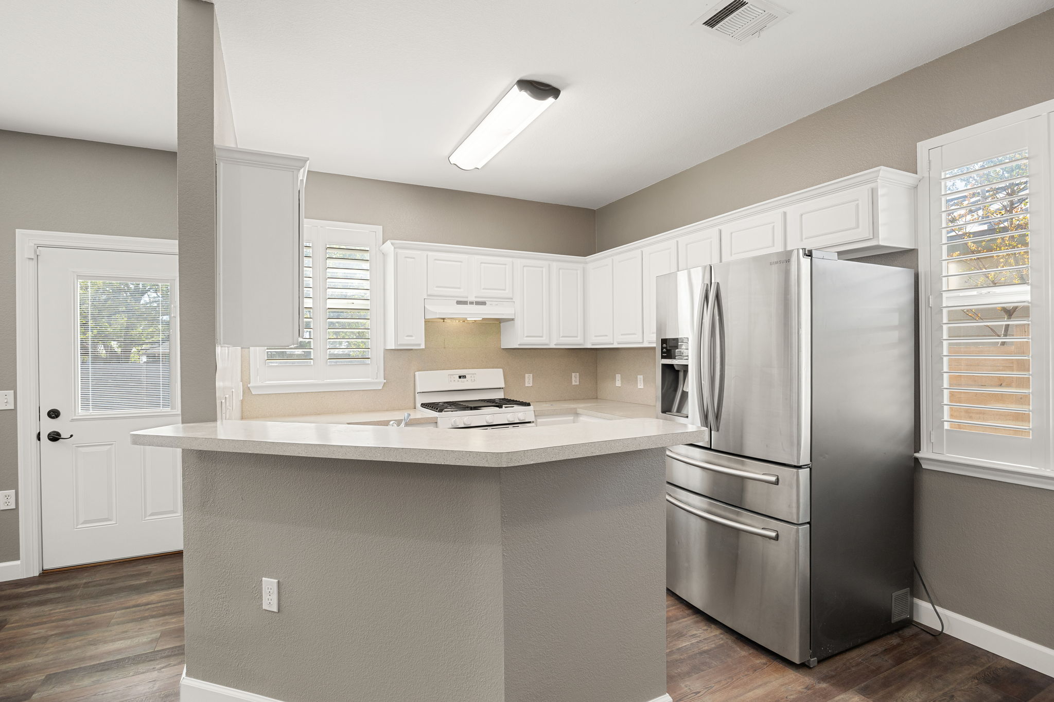 4805 Louis Avenue Austin, TX 78721 - Photo 5 of 23 a kitchen with stainless steel appliances a refrigerator and a window