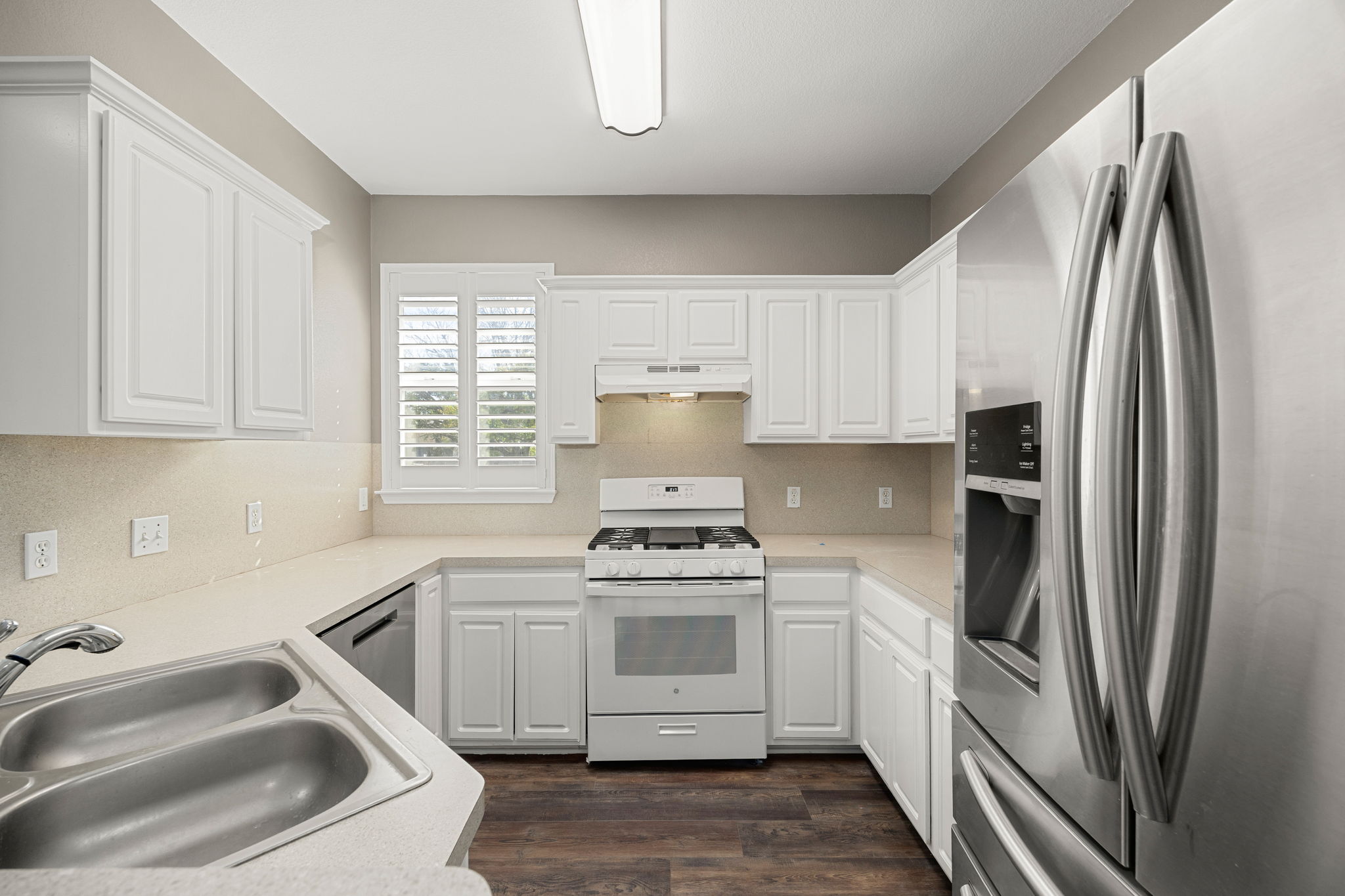 4805 Louis Avenue Austin, TX 78721 - Photo 6 of 23 a kitchen with white cabinets and stainless steel appliances