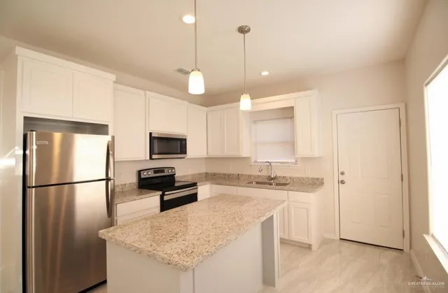 a large white room with a large window and chandelier