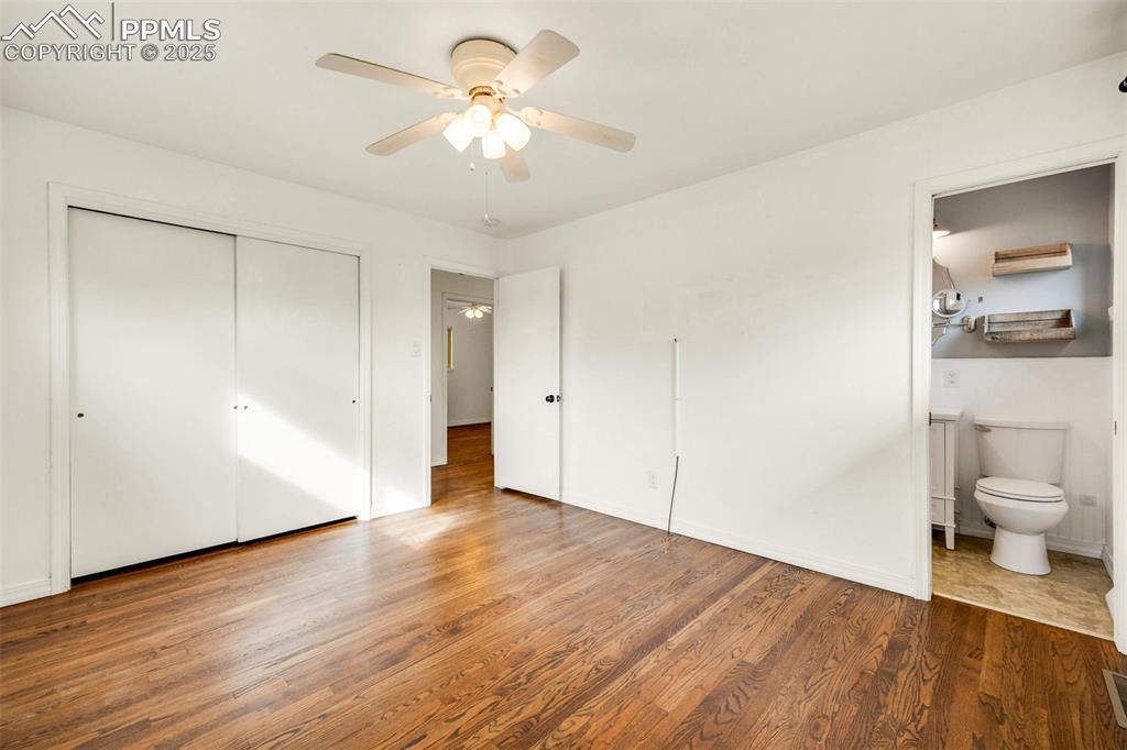 24 Drake Street Pueblo, CO 81005 - Photo 19 of 29 a view of a room with wooden floor and a ceiling fan
