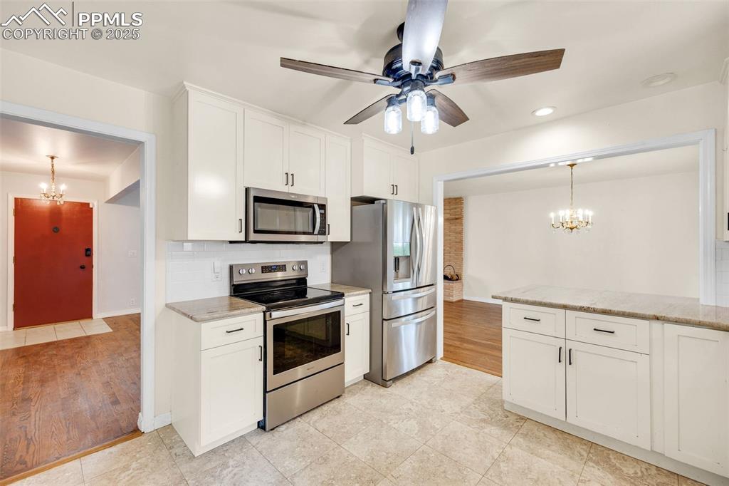 24 Drake Street Pueblo, CO 81005 - Photo 9 of 29 a kitchen with white cabinets and stainless steel appliances