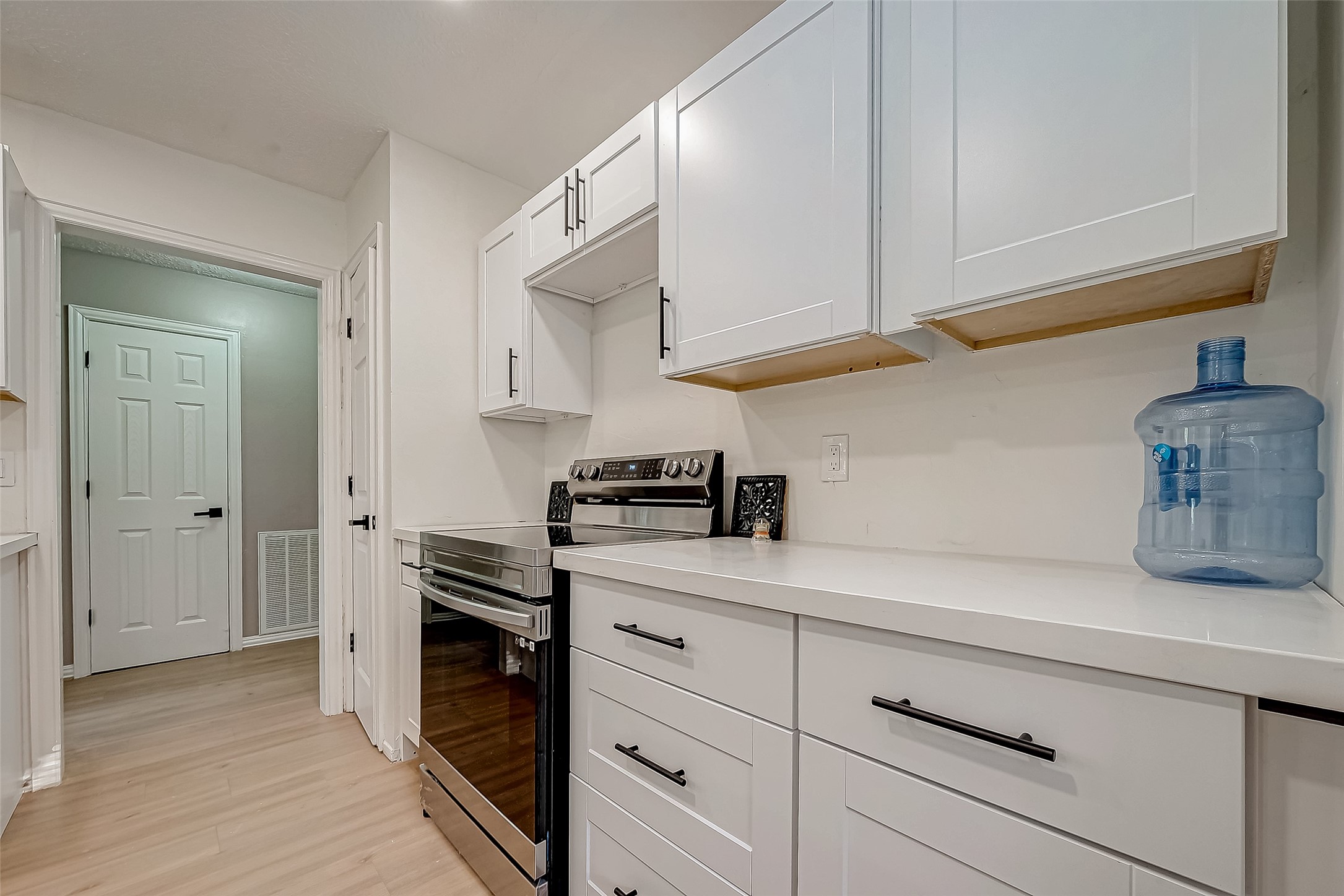 4731 Casemont Drive Spring, TX 77388 - Photo 13 of 50 a kitchen with stainless steel appliances white cabinets and a wooden floor