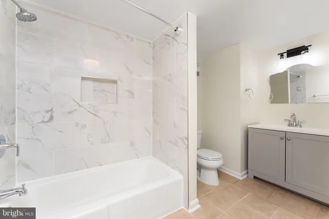 a bathroom with a double vanity sink toilet and shower
