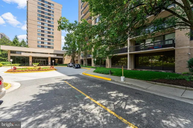 a view of street with houses and trees in the background