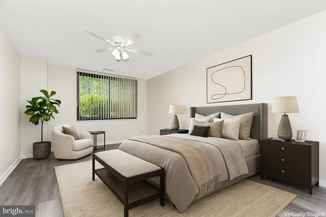 a large bedroom with a bed and wooden floor