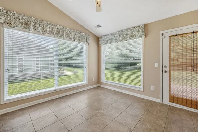 a view of an empty room with glass door