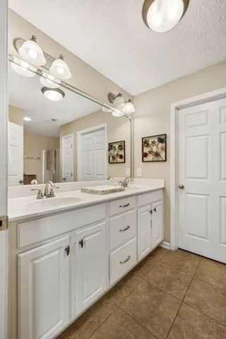 a spacious bathroom with a granite countertop sink a mirror and a