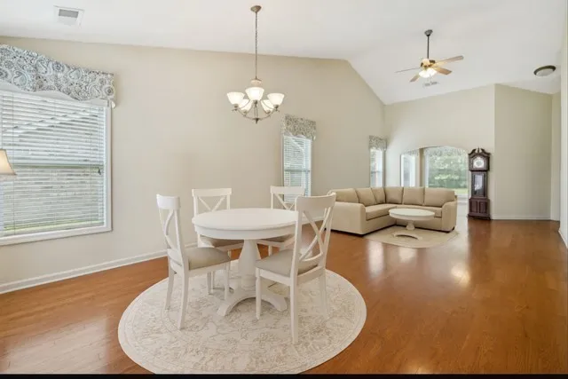 a view of a dining room with furniture wooden floor and chandelier