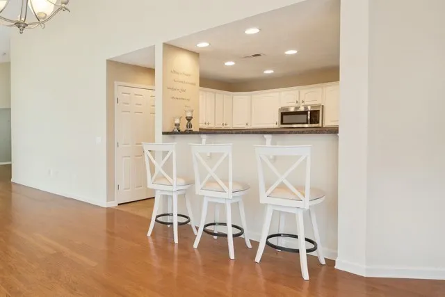 a view of dining room with furniture and wooden floor
