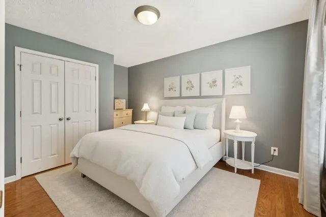 a bedroom with a bed and a lamp