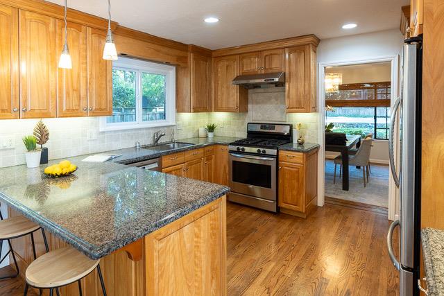 3523 Oak Drive Menlo Park, CA 94025 - Photo 5 of 20 a kitchen with stainless steel appliances granite countertop a sink a stove and a wooden floors
