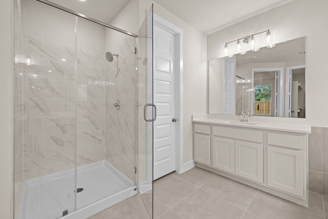621 Buckaroo Drive Georgetown, TX 78633 - Photo 11 of 30 a bathroom with a shower and a sink