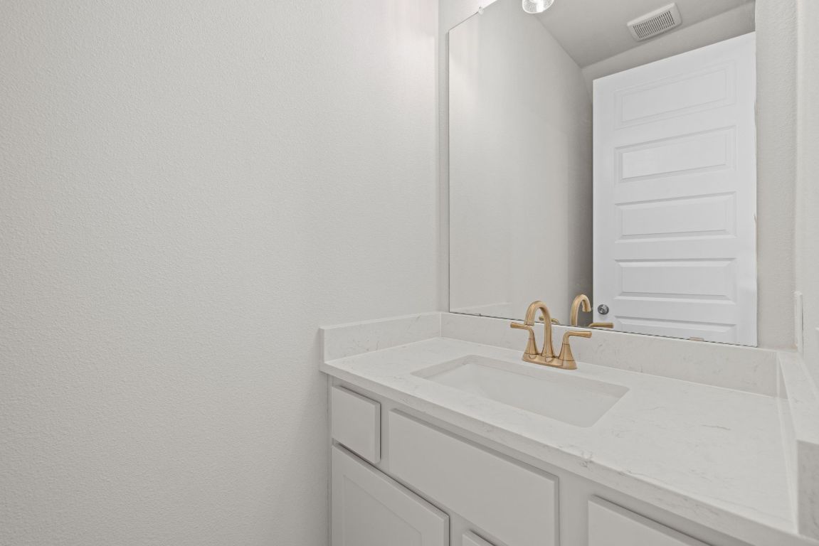 621 Buckaroo Drive Georgetown, TX 78633 - Photo 13 of 30 a bathroom with a sink and a mirror