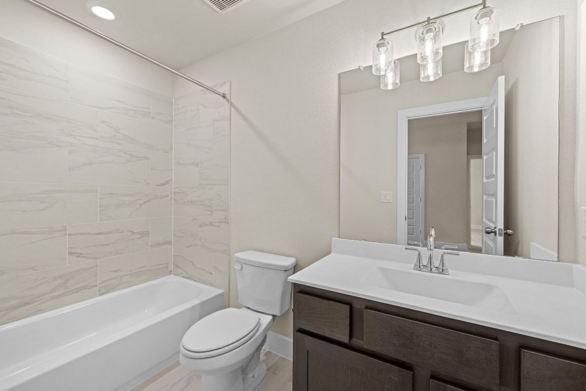 621 Buckaroo Drive Georgetown, TX 78633 - Photo 18 of 30 a bathroom with a sink a toilet and shower