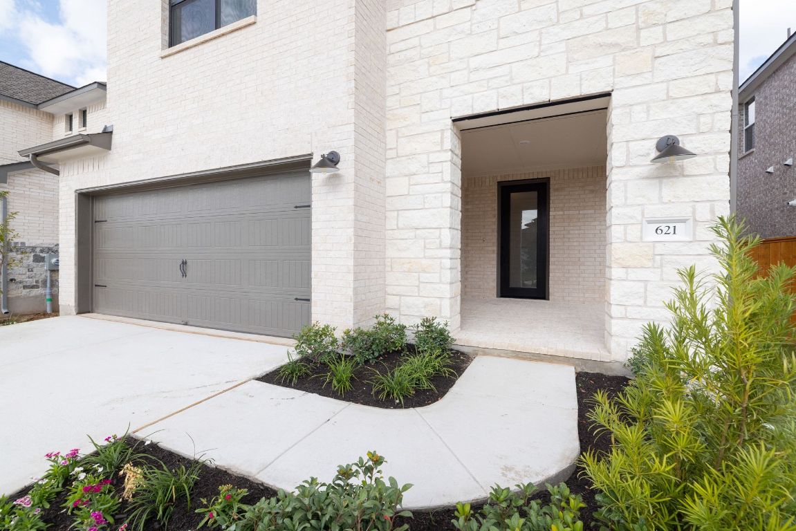 621 Buckaroo Drive Georgetown, TX 78633 - Photo 2 of 30 a potted plant sitting in front of a house
