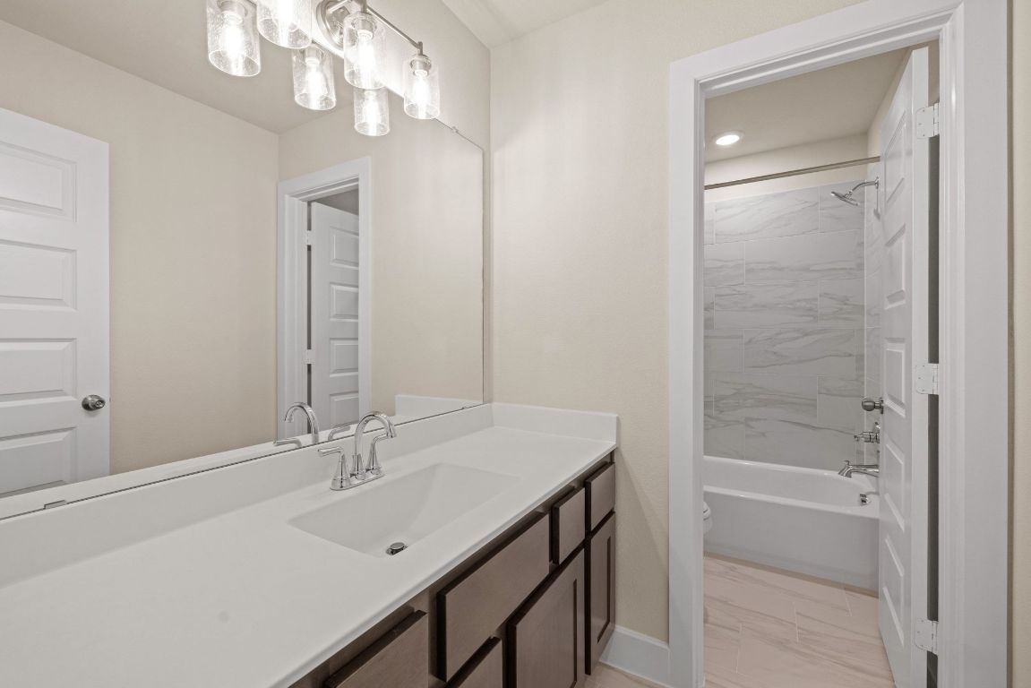 621 Buckaroo Drive Georgetown, TX 78633 - Photo 21 of 30 a bathroom with a sink a light fixture and a mirror