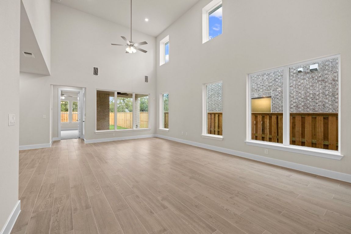 621 Buckaroo Drive Georgetown, TX 78633 - Photo 5 of 30 a view of an empty room with a window and wooden floor