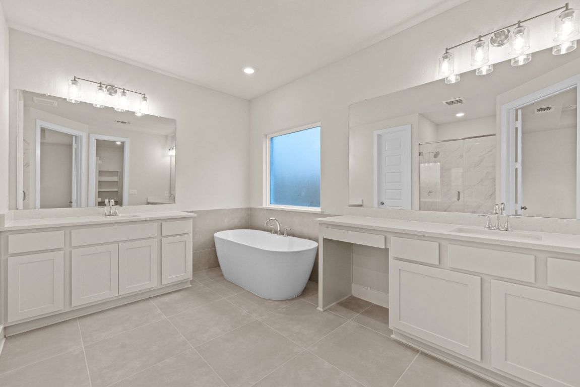 621 Buckaroo Drive Georgetown, TX 78633 - Photo 10 of 30 a spacious bathroom with a granite countertop sink mirror and bathtub