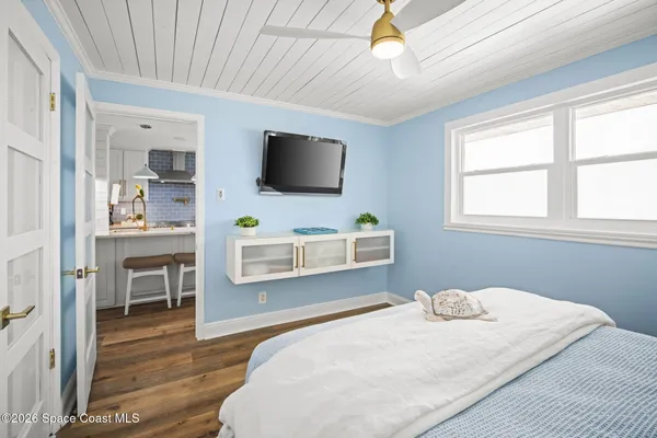 a bedroom with a large bed and a flat screen tv
