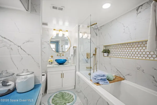 a bathroom with a sink mirror and toilet