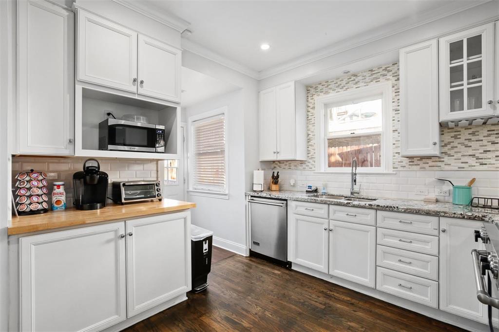5227 Homer Street Dallas, TX 75206 - Photo 13 of 36 a kitchen with cabinets appliances a sink and a window