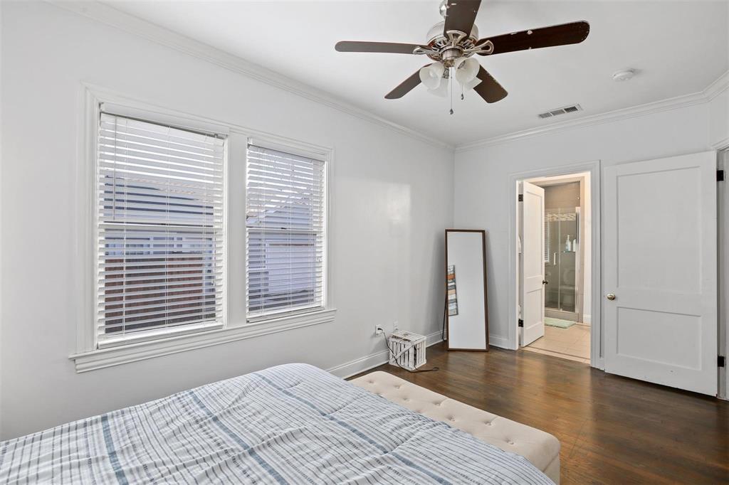 5227 Homer Street Dallas, TX 75206 - Photo 17 of 36 a bedroom with a bed and a chandelier