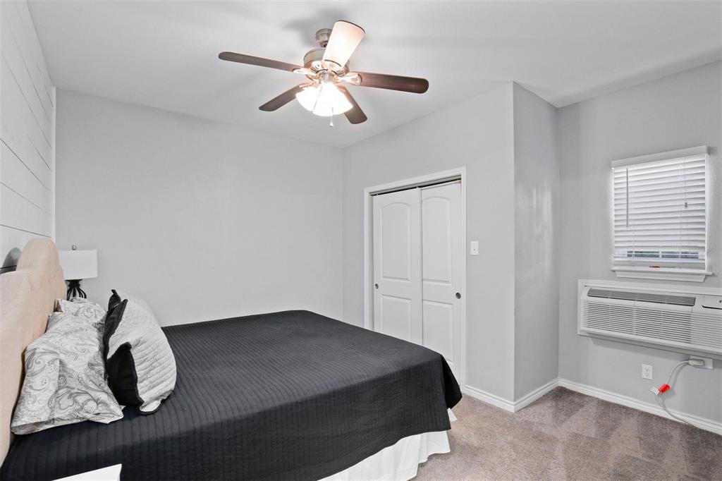 5227 Homer Street Dallas, TX 75206 - Photo 34 of 36 a bedroom with a bed and a chandelier