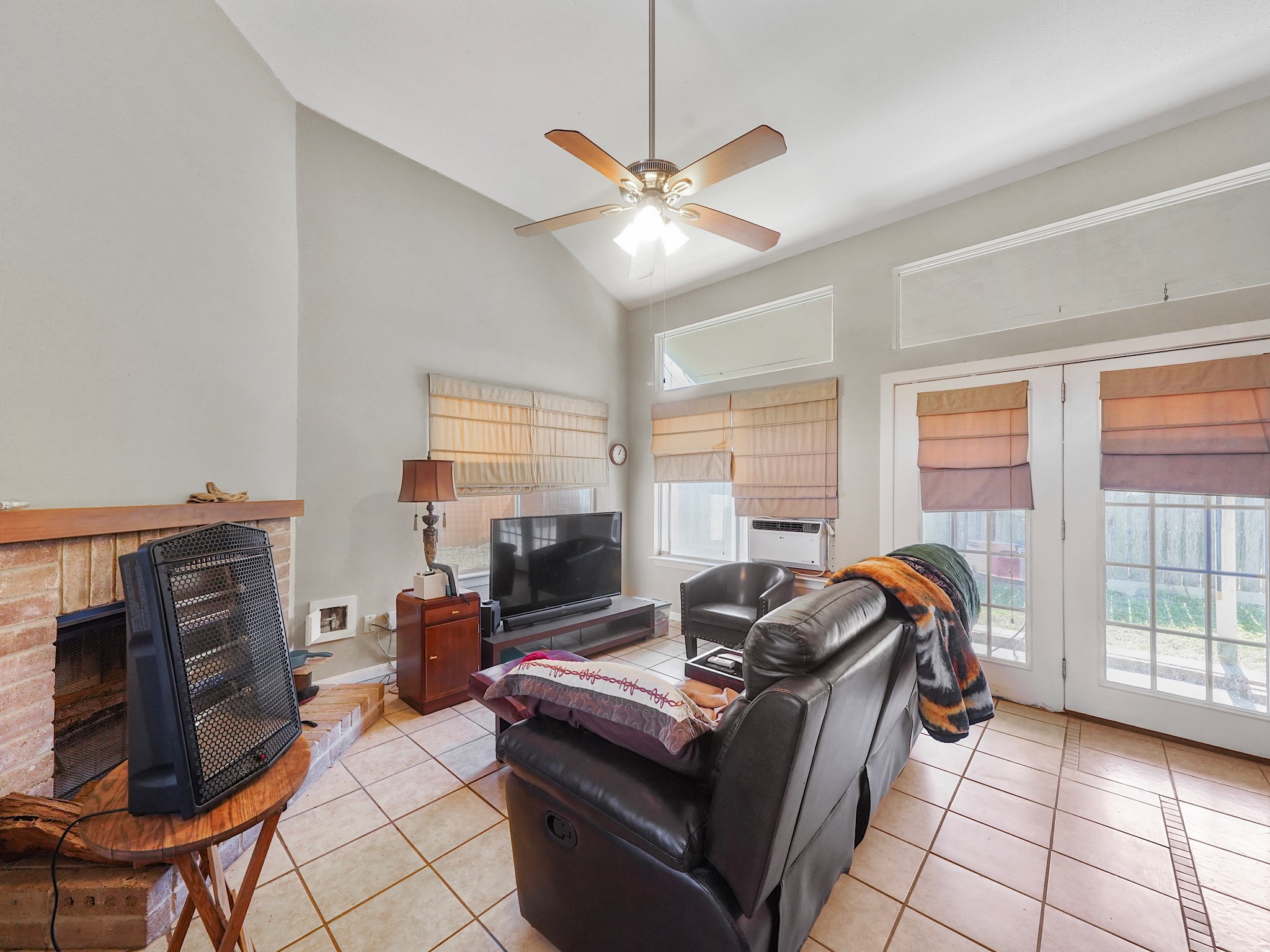 18527 Trail Bend Lane Houston, TX 77084 - Photo 3 of 18 At the back of the home you'll find a wall of windows that shower light into the living room.
