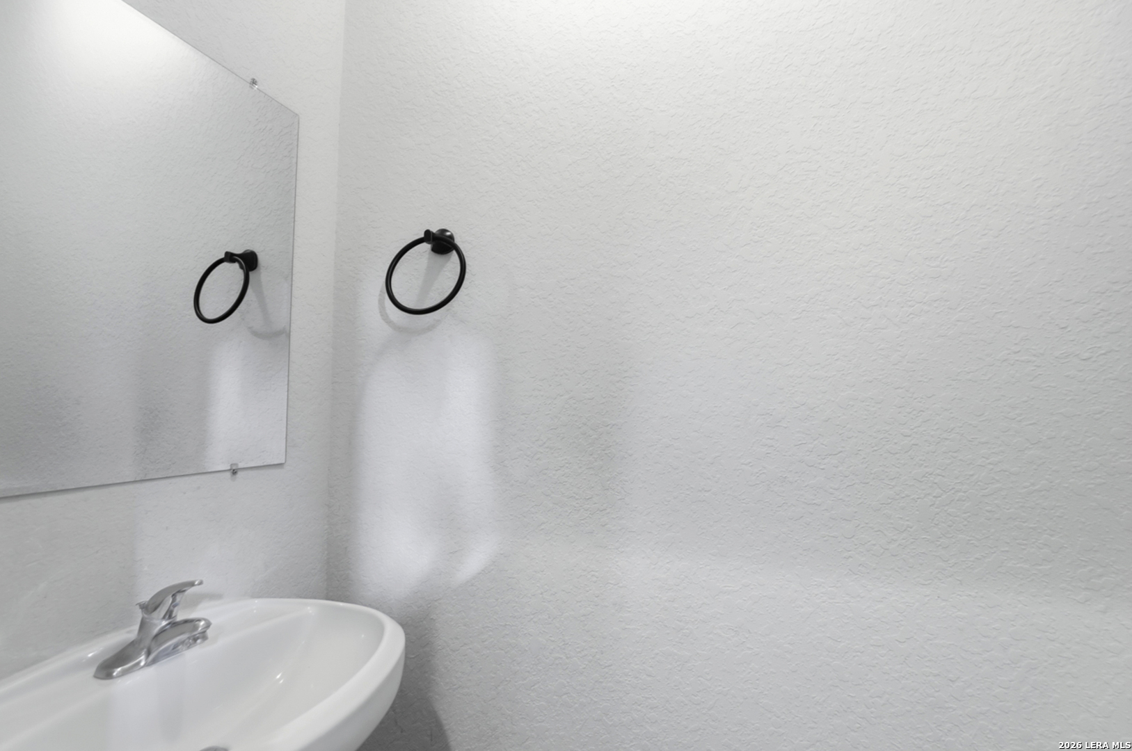 16821 Showdown Path, Unit 3 Schertz, TX 78154 - Photo 12 of 25 a bathroom with a sink and a mirror