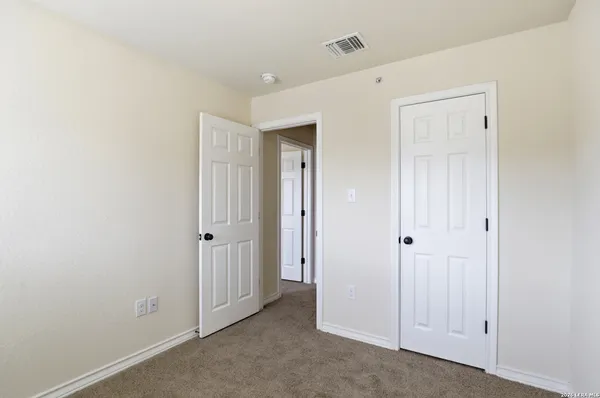 an empty room with closet area