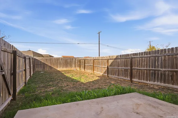 a view of a backyard with a fence