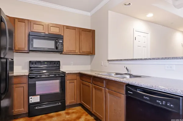 a kitchen with stainless steel appliances granite countertop a stove microwave and sink