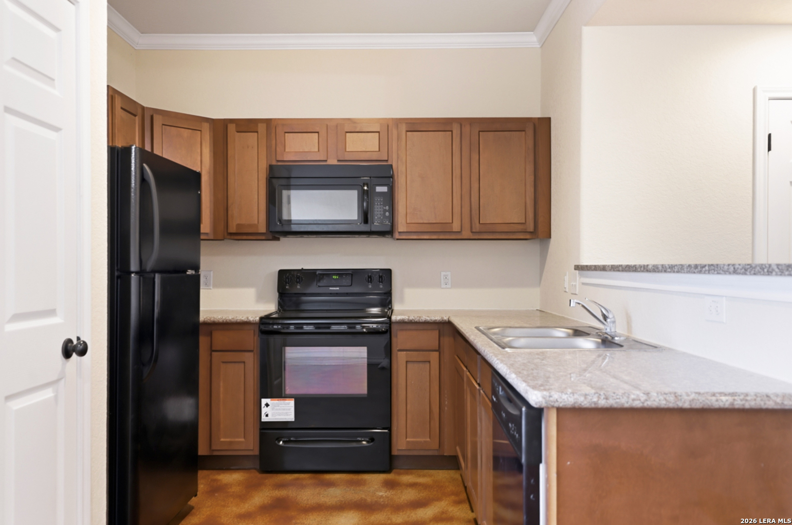 16821 Showdown Path, Unit 3 Schertz, TX 78154 - Photo 9 of 25 a kitchen with granite countertop a refrigerator stove and microwave