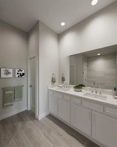 a spacious bathroom with a double vanity sink and mirror