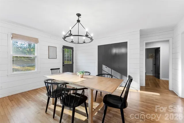 a view of a dining room with furniture window and wooden floor