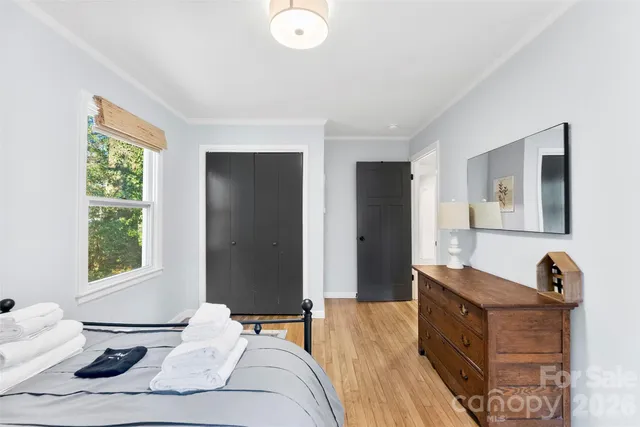 a bedroom with furniture and a window