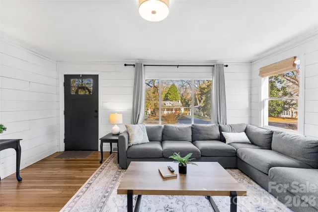 a living room with furniture and wooden floor