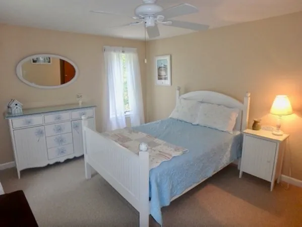 a bedroom with a bed and a dresser