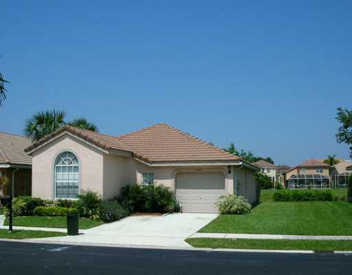 10251 Breezeway Place Boca Raton, FL 33428 - Photo 1 of 20 a front view of a house with a yard