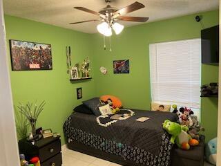 10251 Breezeway Place Boca Raton, FL 33428 - Photo 13 of 20 a bedroom with a bed potted plant and a potted plant
