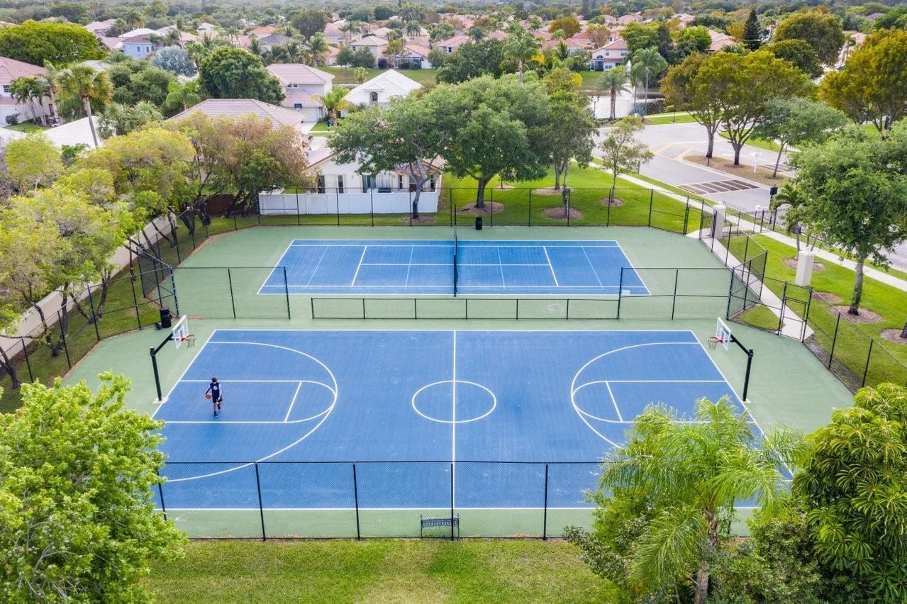 10251 Breezeway Place Boca Raton, FL 33428 - Photo 7 of 20 a view of a tennis ground with a large tree