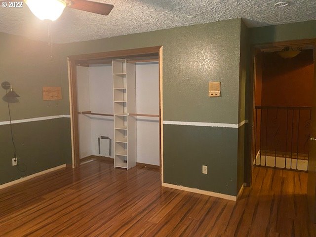 7705 Northeast Quarry Road La Center, WA 98629 - Photo 11 of 27 an empty room with wooden floor and windows