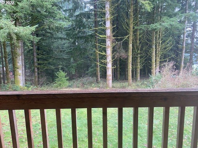 7705 Northeast Quarry Road La Center, WA 98629 - Photo 13 of 27 a view of a wooden balcony with trees