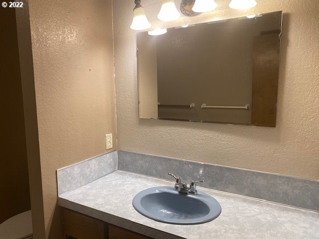 7705 Northeast Quarry Road La Center, WA 98629 - Photo 15 of 27 a bathroom with a sink and a mirror