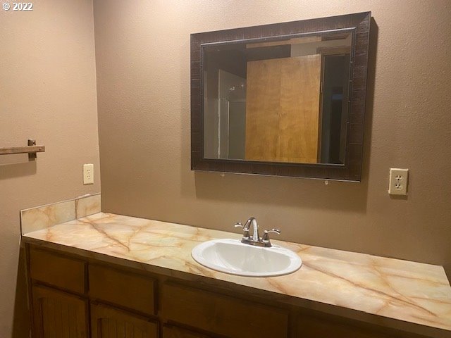7705 Northeast Quarry Road La Center, WA 98629 - Photo 18 of 27 a bathroom with a sink and a mirror