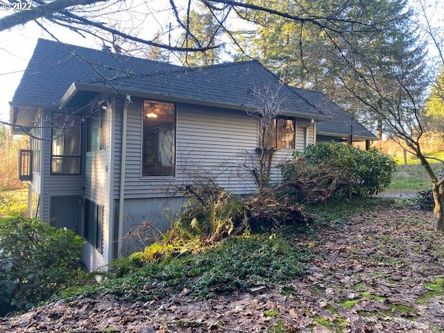 7705 Northeast Quarry Road La Center, WA 98629 - Photo 25 of 27 a view of a brick house with a large tree