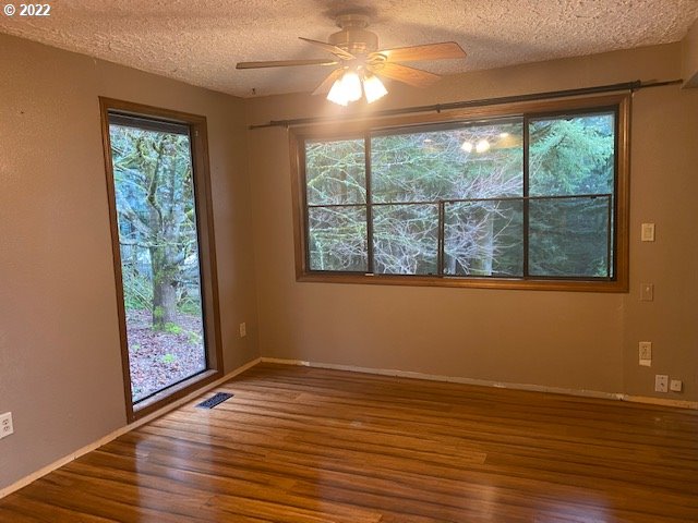 7705 Northeast Quarry Road La Center, WA 98629 - Photo 9 of 27 a view of empty room with wooden floor and fan