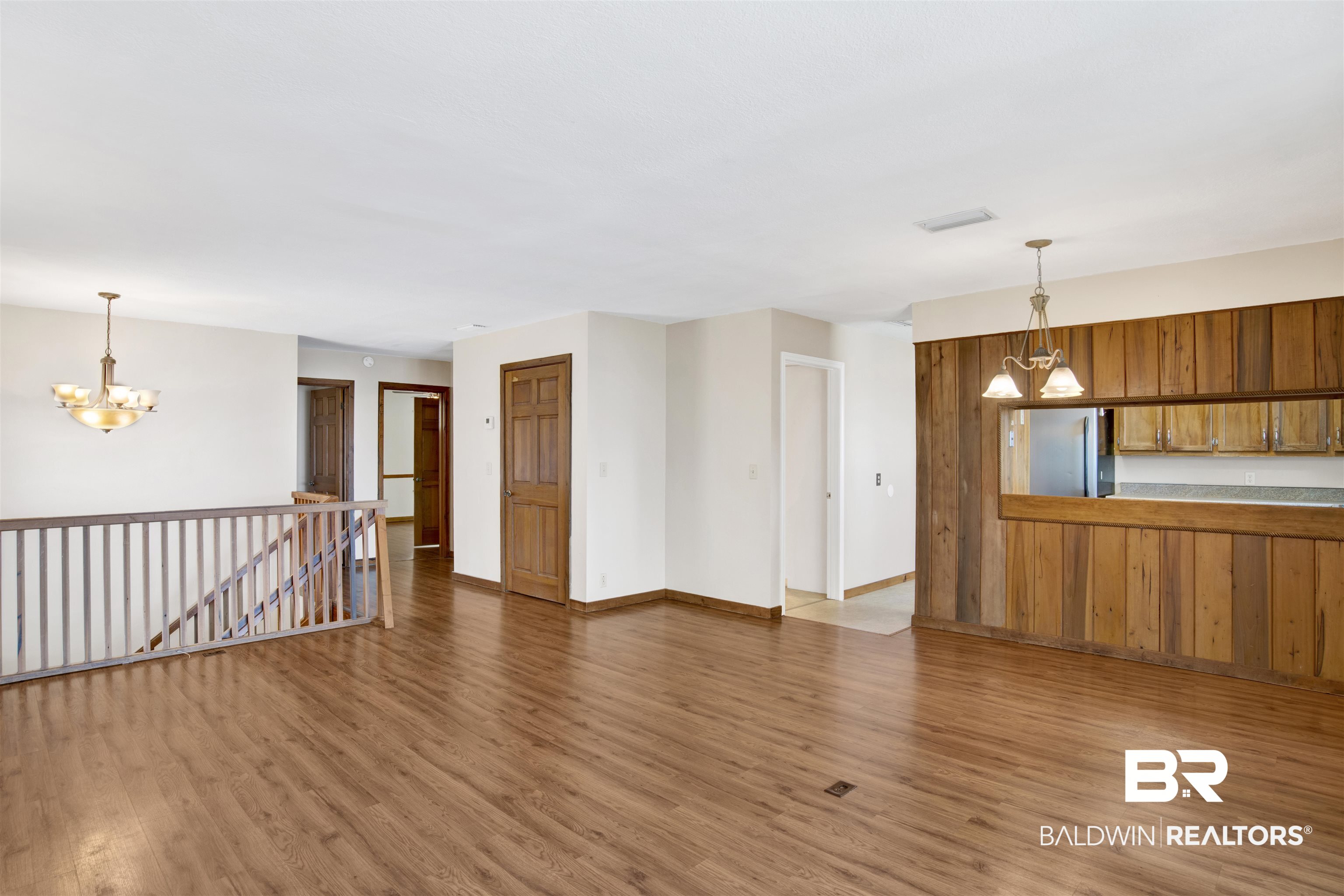 7411 Bay Road Mobile, AL 36605 - Photo 12 of 34 Unfurnished living room featuring a chandelier and light wood-style flooring