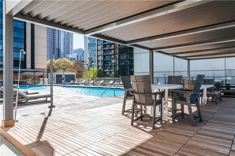 a view of a patio with dining table and chairs with wooden floor