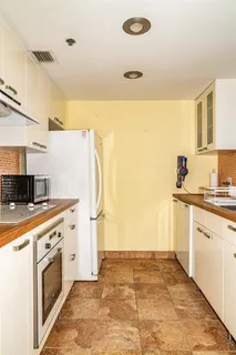 a kitchen with a stove a refrigerator and a sink